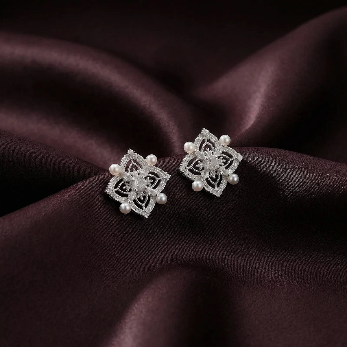 Filigree Pearl Bloom Studs on a fabric