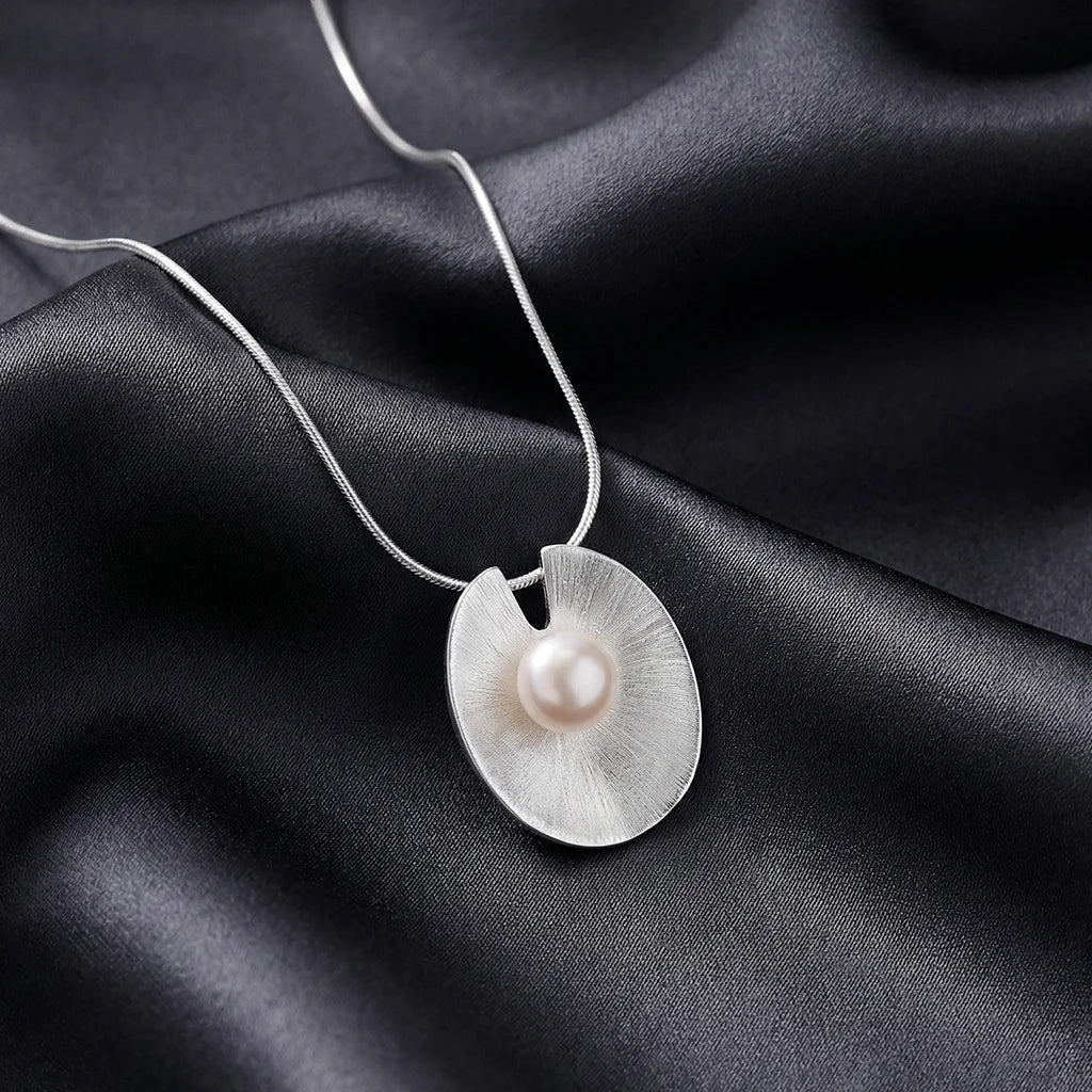Luna Disc Pearl Pendant on a fabric