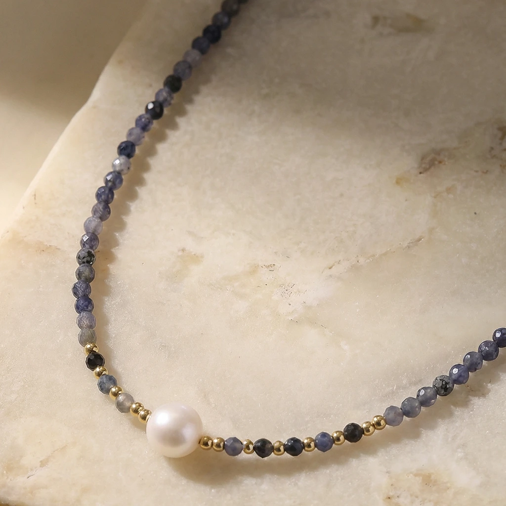 Twilight Iolite Pearl Necklace on a stone slab