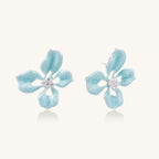 Light blue flower-shaped earrings on a white background