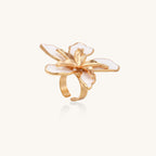 Gold-plated adjustable ring with large white enamel flower design featuring smooth petals outlined in gold