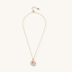 Gold-plated circular pendant featuring pink enamel rose with pearl accents and green leaf details on adjustable chain.