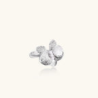 Silver-toned orchid ring with textured petals, pearl center accents, and sparkling zirconia stones on white background.