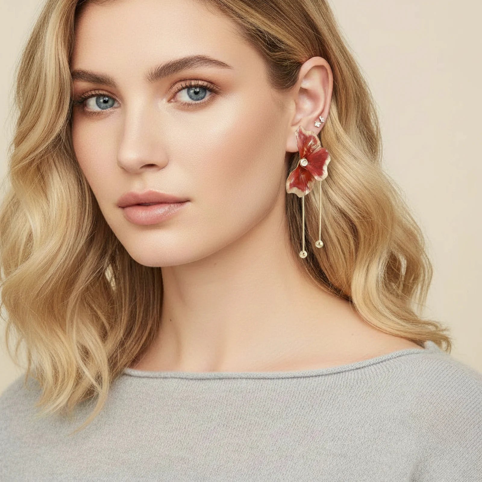 Woman wearing a floral earring with a beige background