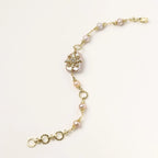 Gold-plated bracelet with pink baroque pearl centerpiece, floral connector, and freshwater pearls