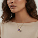 Close-up of a woman wearing a gold necklace with a floral pendant.