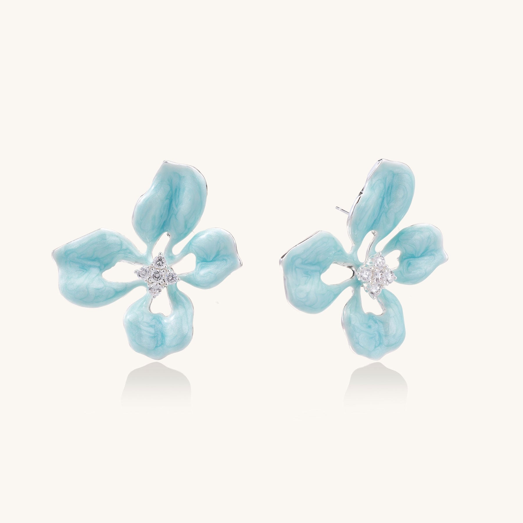 Light blue flower-shaped earrings on a white background