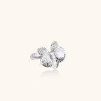 Silver-toned orchid ring with textured petals, pearl center accents, and sparkling zirconia stones on white background.
