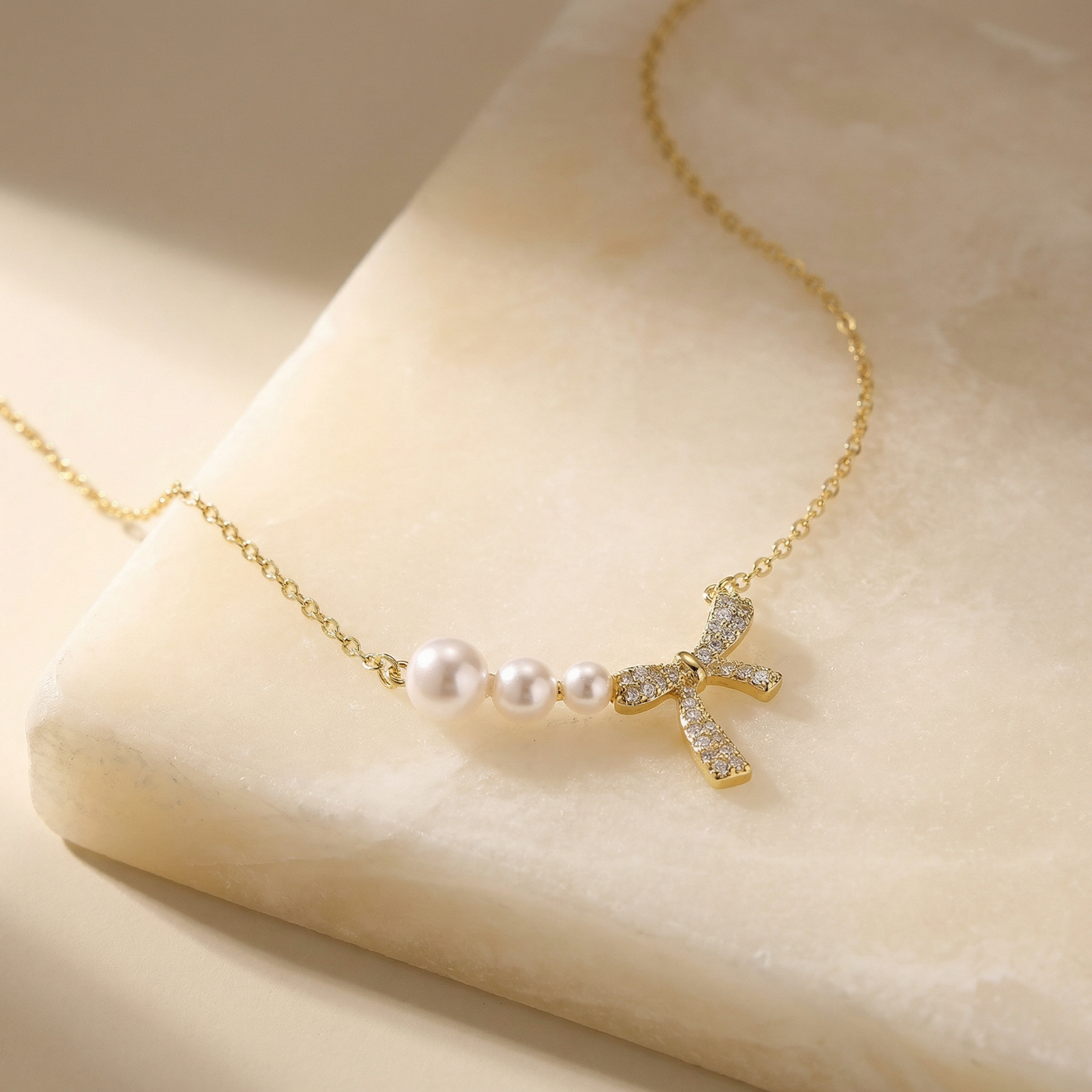 Bow and Pearl Necklace on a stone