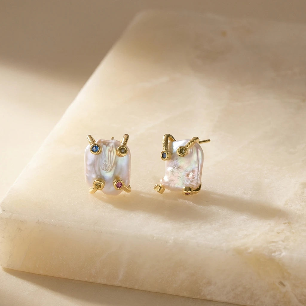 Elemental Baroque Pearl Earrings on a stone