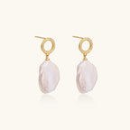 18K gold vermeil twisted circle studs with organic white baroque pearl drops on cream background