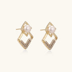 geometric Gold earrings with pearl centers on a white background
