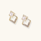 Gold earrings with pearl and zirconia accents on a white background