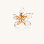 Gold-plated adjustable ring with large white enamel flower design featuring smooth petals outlined in gold