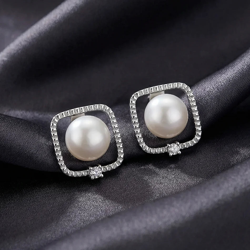 halo frame pearl stud earrings on fabric