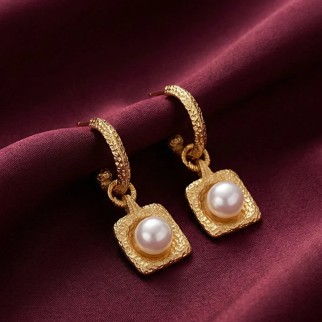 Hammered Pearl Drop Hoops on a fabric