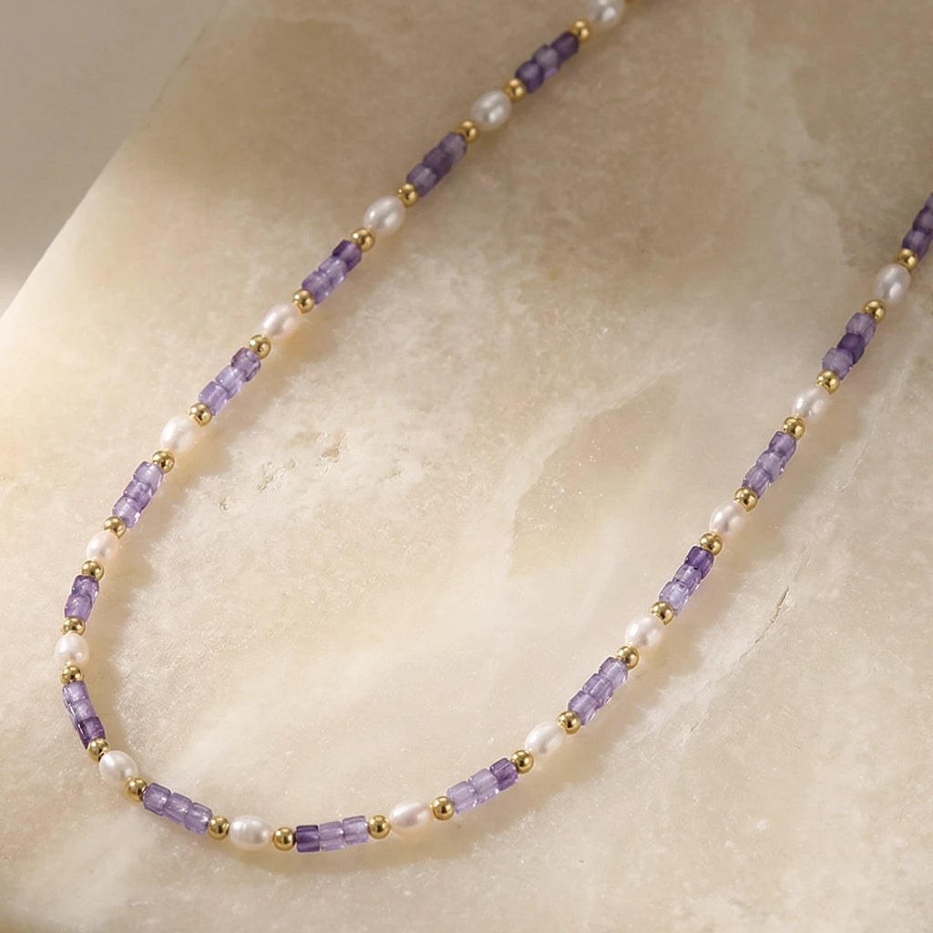Lavender Harmony Pearl Necklace on a stone slab