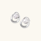 White gold-plated brass earrings with circular design, freshwater pearl center, and diamond accents