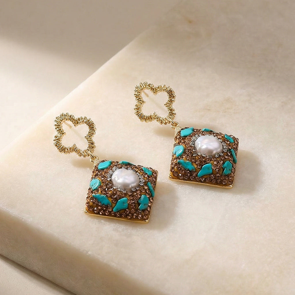 Ornamental Grounding Drop Earrings on a stone slab