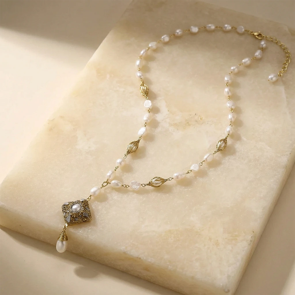 Ornate Pearl Y-Drop Necklace on a stone