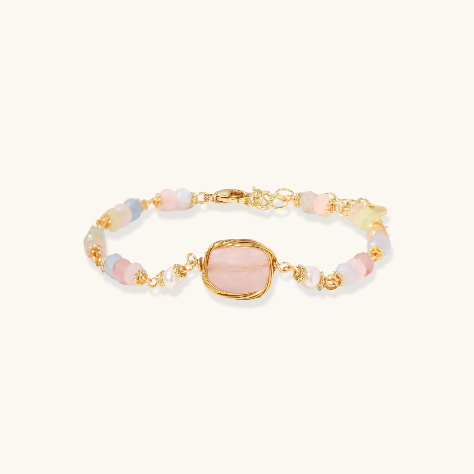 Delicate beaded bracelet with pastel rose quartz, pearls, and pink cushion-cut centerpiece in gold-plated setting