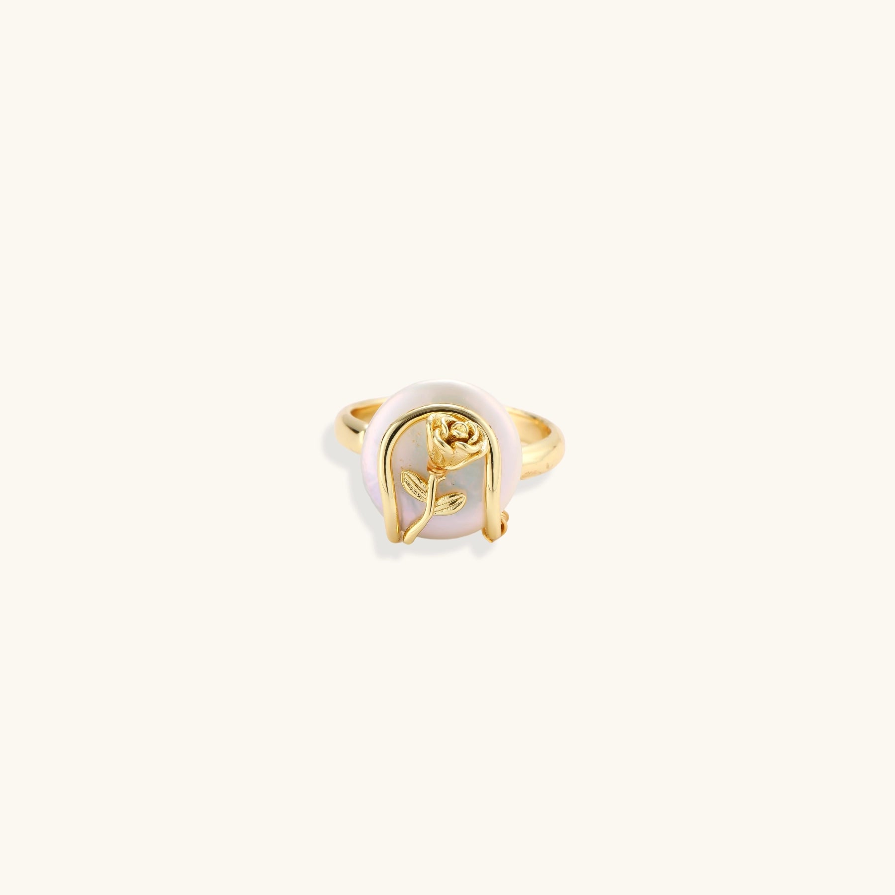 Gold-plated sculptural ring featuring a baroque pearl wrapped in a delicate rose and vine cage design