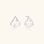 Pearl earrings with silver hooks on a white background