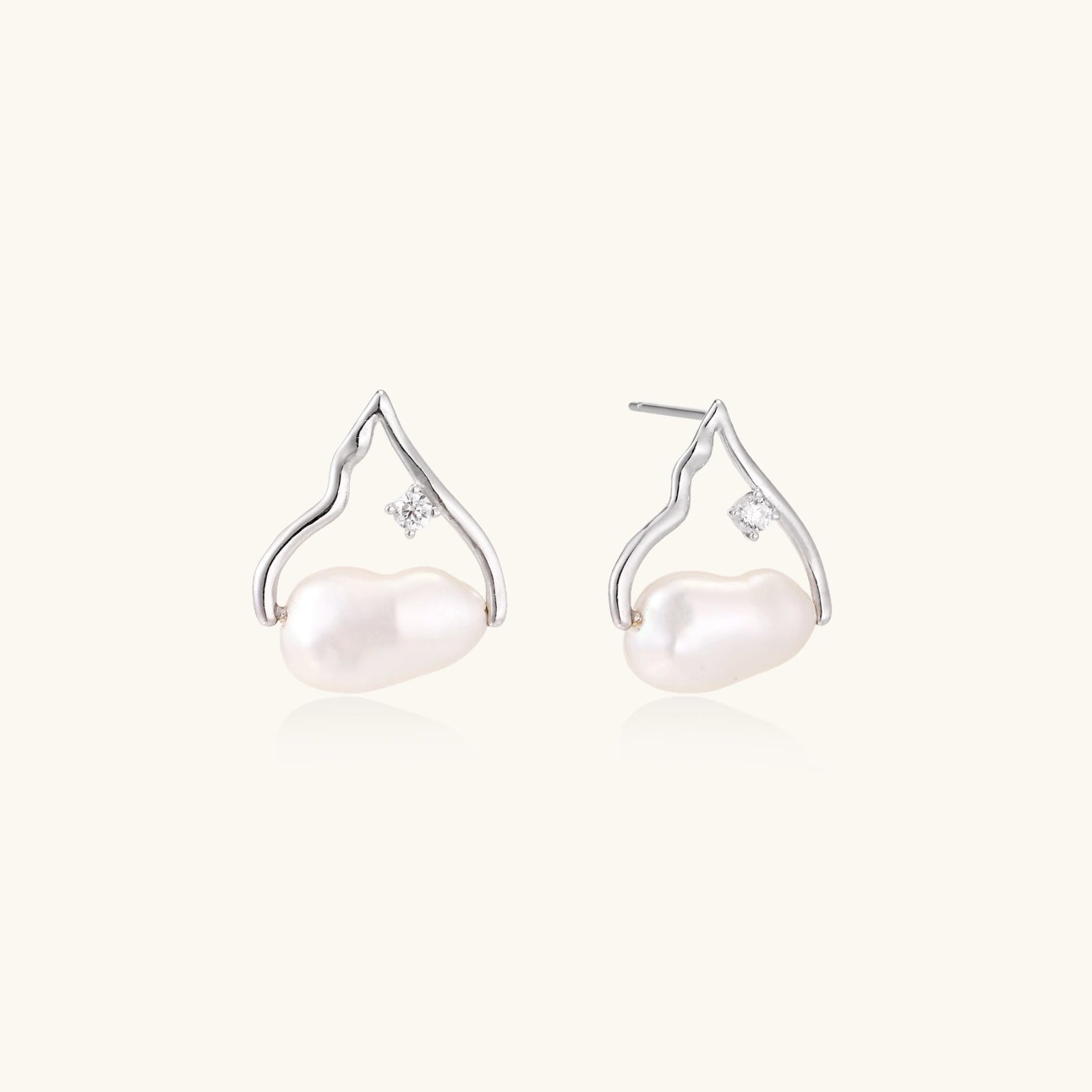 Pearl earrings with silver hooks on a white background