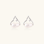 Pair of pearl earrings with silver hooks on a white background
