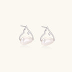 Pair of pearl earrings with silver hooks on a white background