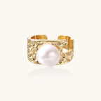 Wide gold-plated ring with organic textured band and white freshwater pearl centerpiece