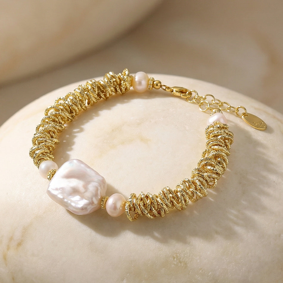bracelet featuring textured gold and a baroque pearl