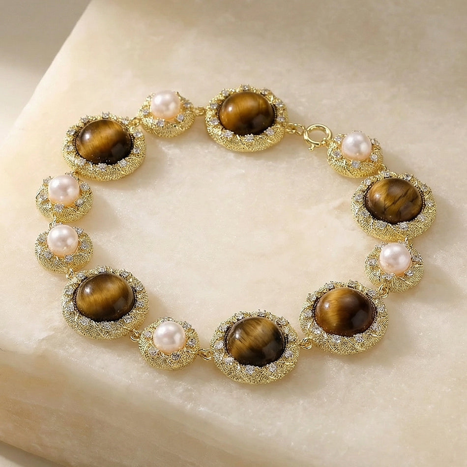 tiger's eye and pearl bracelet on a stone slab
