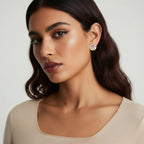 Woman wearing earrings with a neutral background